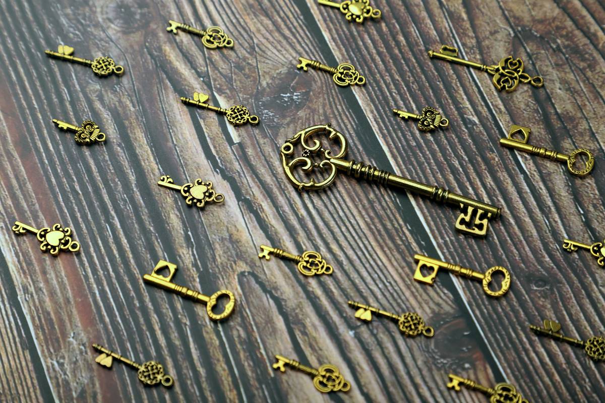 Antique Golden Keys on Wooden Background