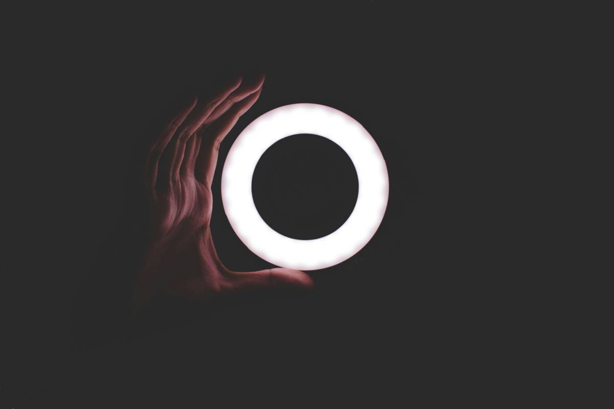 Streamer using professional video equipment light benefit of live setup with softboxes and backlight
